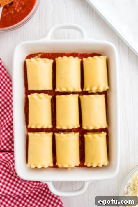 lasagna rolls placed in the baking dish on top of the marinara sauce.