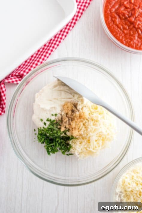 garlic, ricotta, basil and cheese in a bowl.