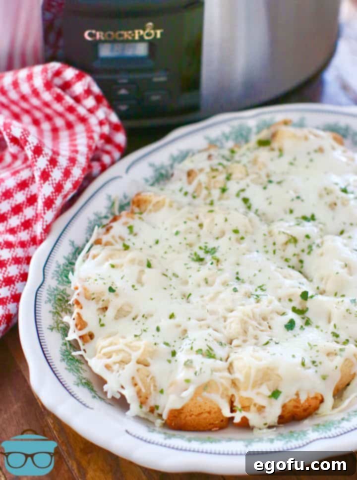 The fully assembled cheese garlic pull apart bread presented on an oval serving plate, ready to be enjoyed.