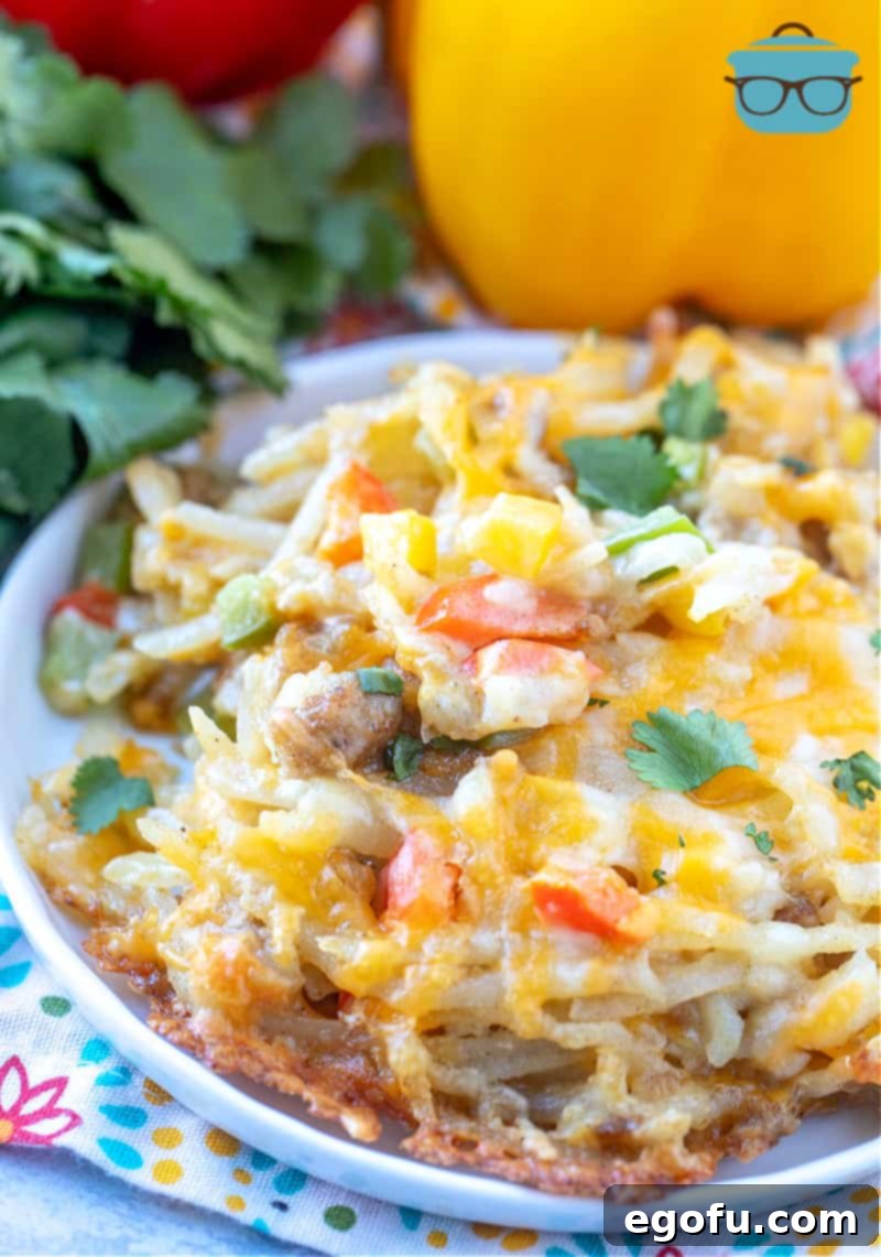 Lone Star Morning Spud Bake 8 A perfectly portioned serving of Texas Hash Brown Casserole on a round white plate, garnished with fresh chopped cilantro, ready to be enjoyed as a hearty breakfast or brunch.