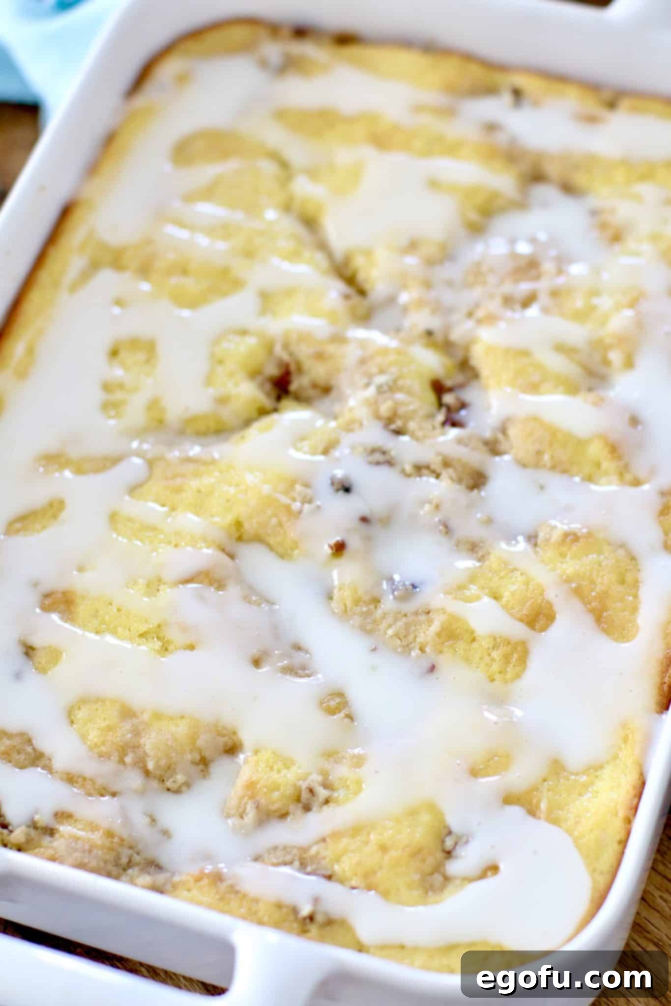 Sunshine Pineapple Crumb Cake 11 Finished, easy pineapple crumb cake with pineapple icing in a white Revol 9x13-inch baking dish