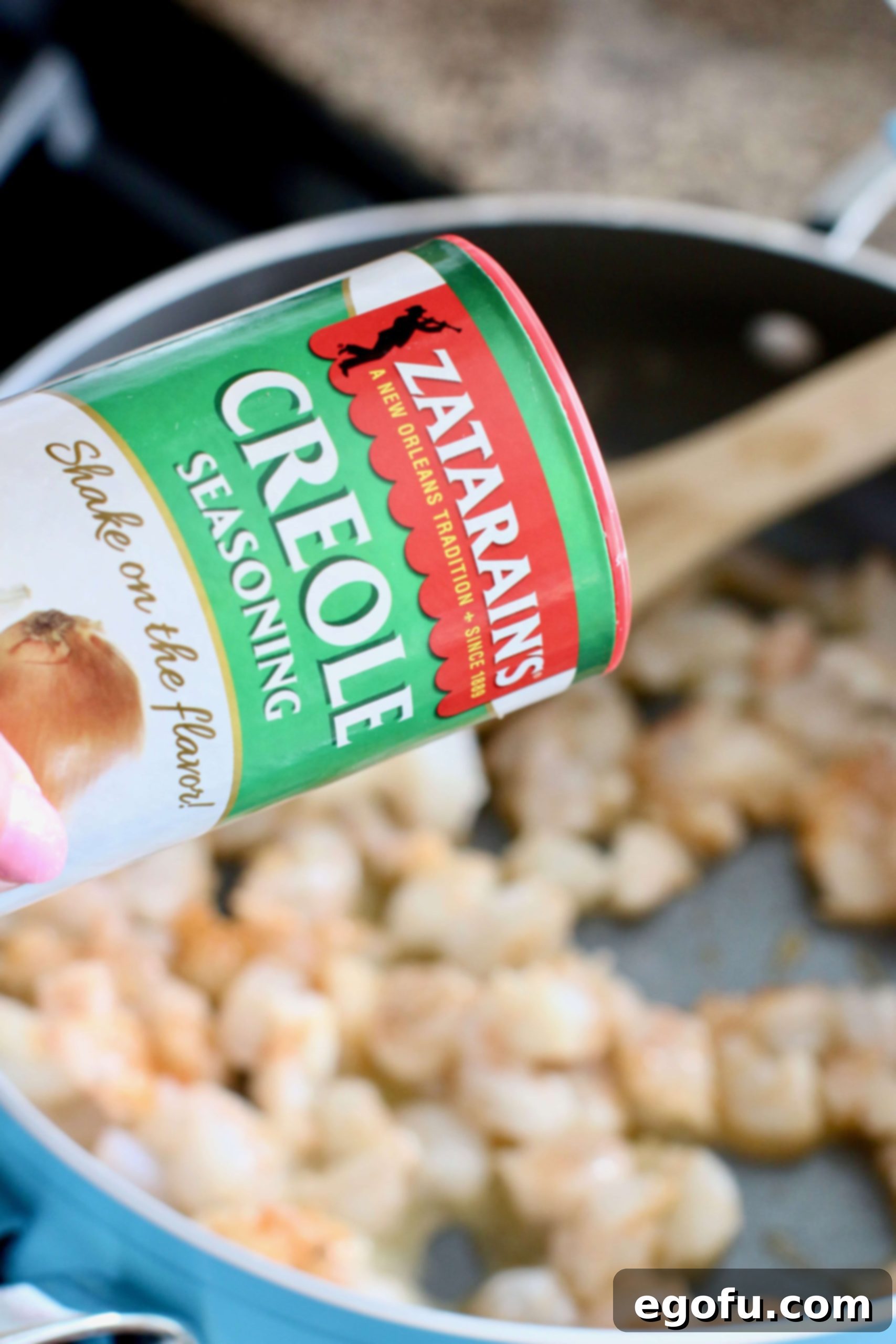 seasoning shrimp in a pan with Zatarain's Creole Seasoning