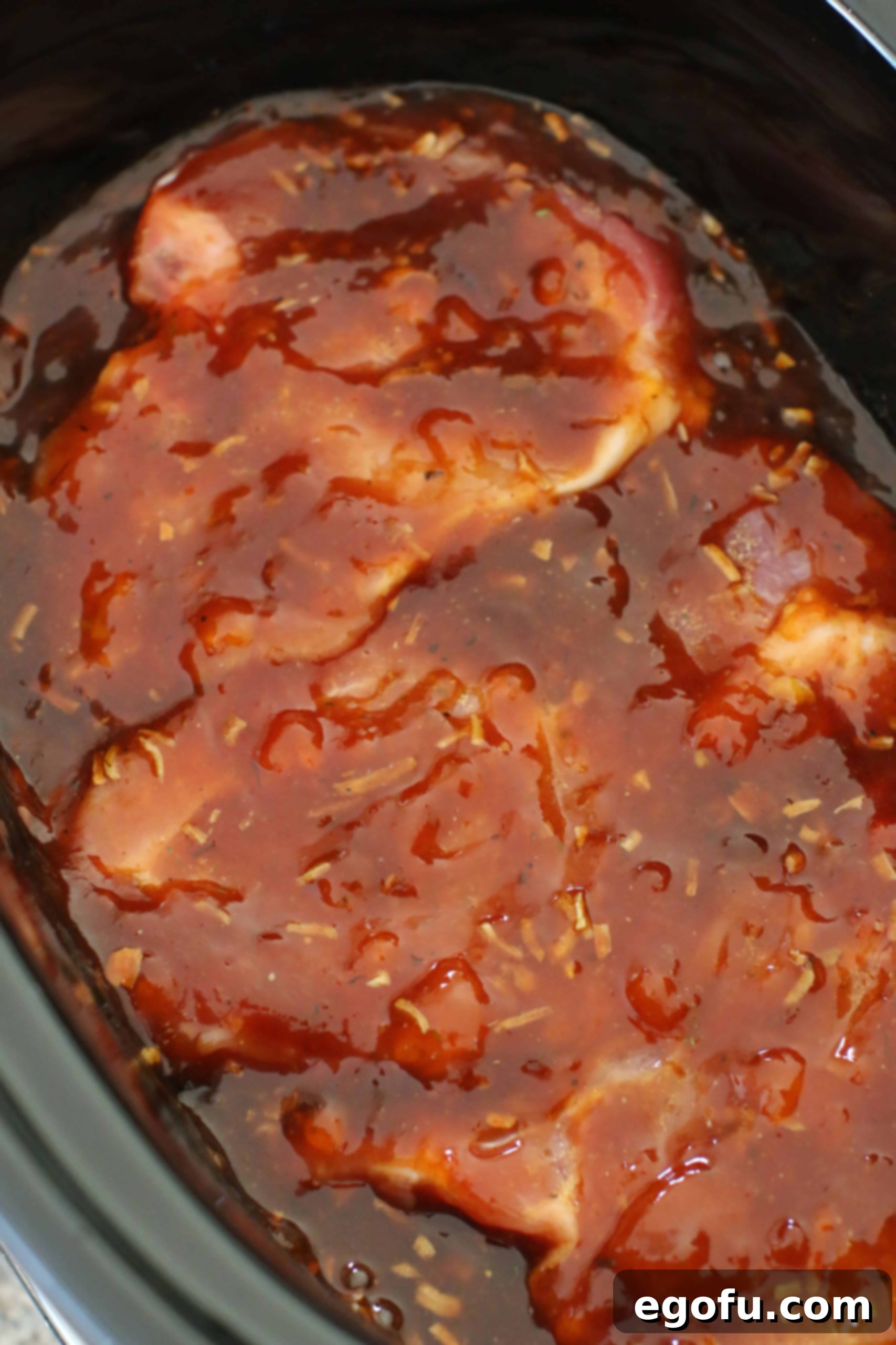 pork chops in barbecue sauce in crock pot.