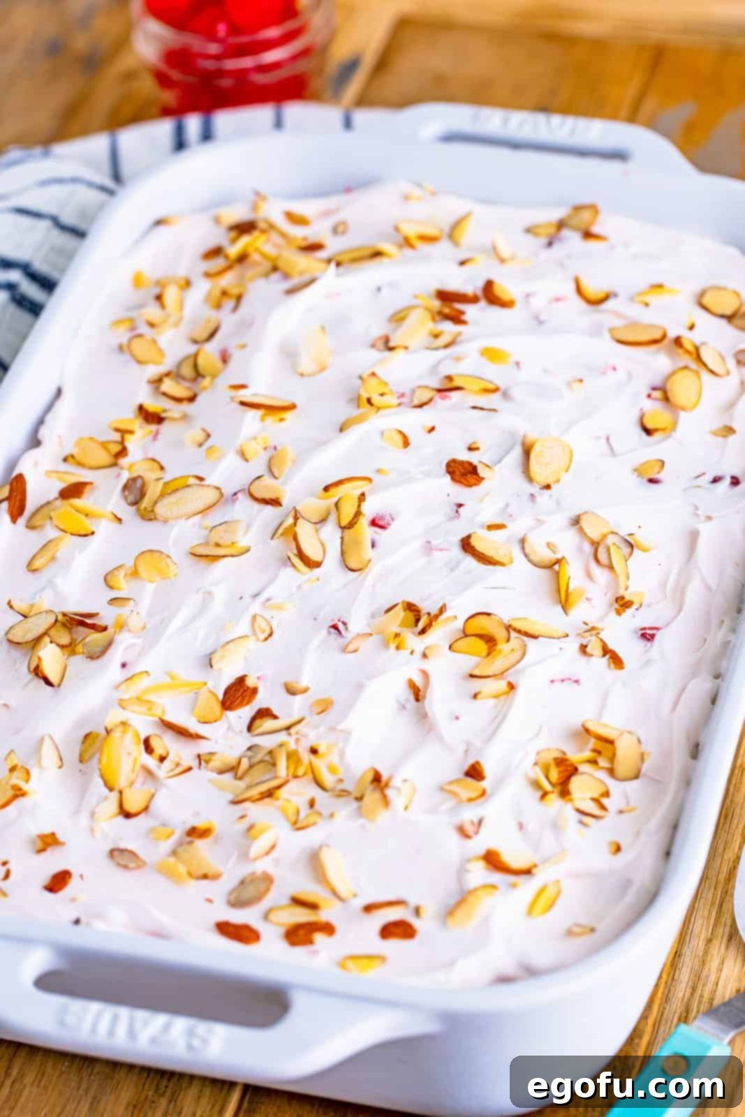 sliced almonds sprinkled evenly on top of cake. 