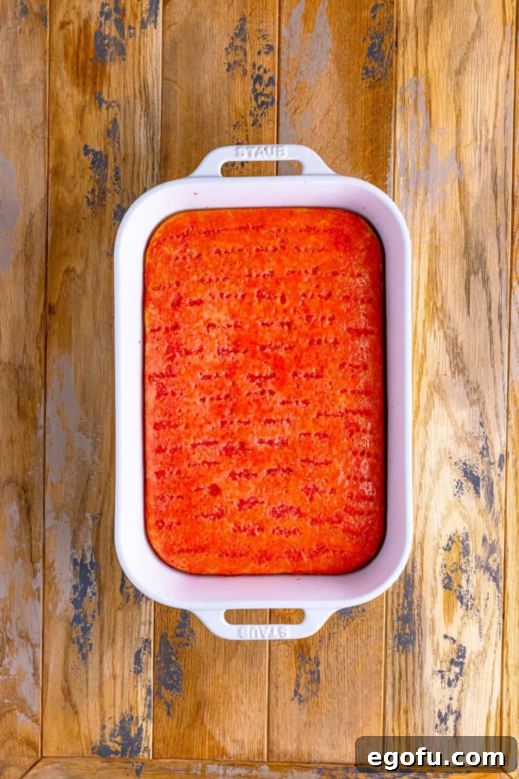 maraschino cherry syrup poured on top of baked cake.