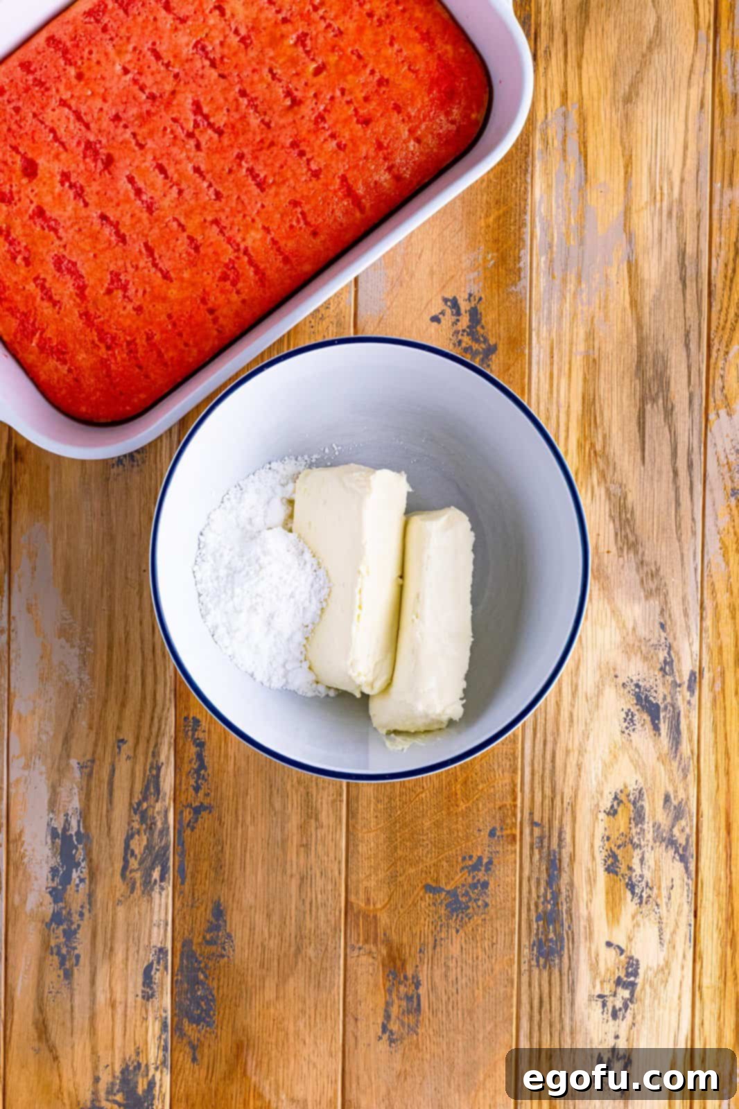 cream cheese and powdered sugar in a white bowl.