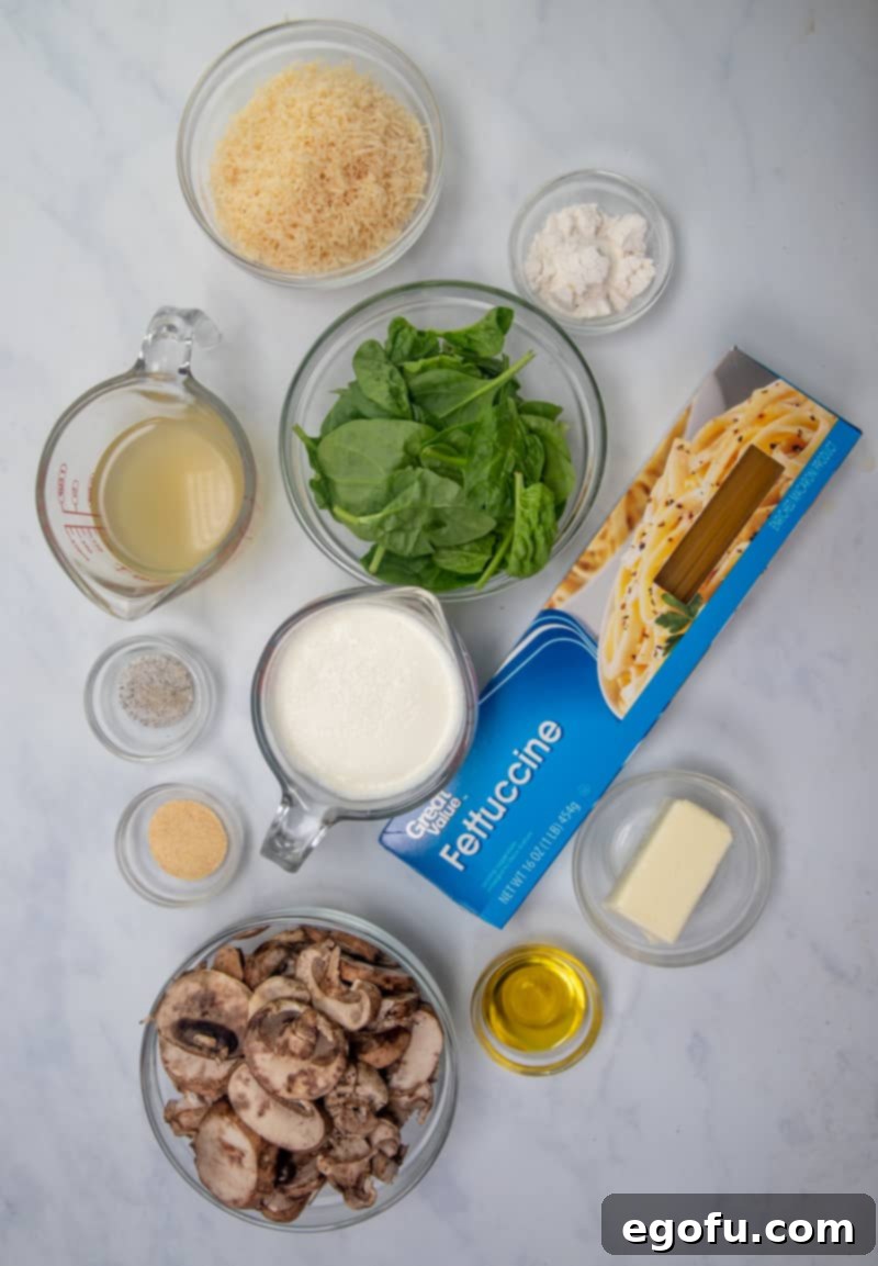 Creamy Garlic Parmesan Fettuccine Alfredo 4 fettuccine noodles, olive oil, baby Bella mushrooms, salted butter, all-purpose flour, chicken broth, heavy cream, freshly grated parmesan cheese, garlic powder (or fresh garlic), salt and pepper, fresh spinach leaves.