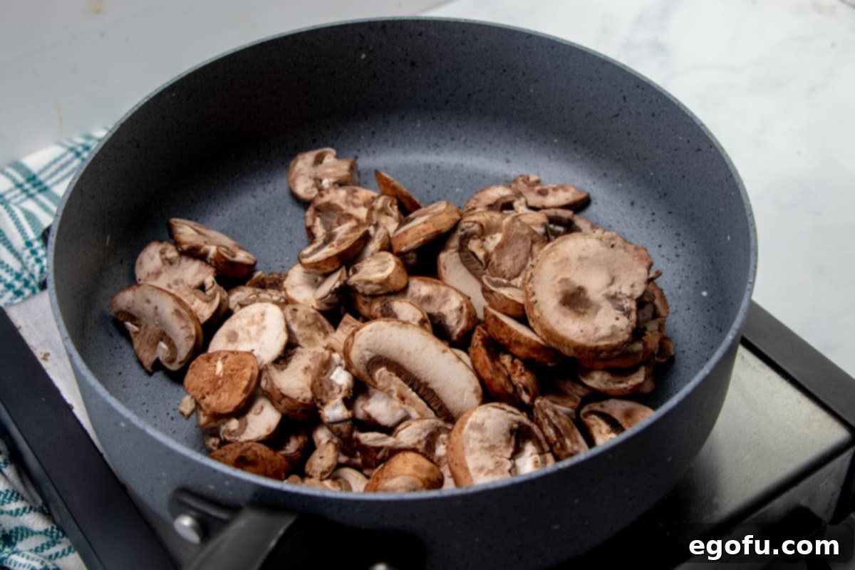 Creamy Garlic Parmesan Fettuccine Alfredo 5 baby Bella mushrooms in a large skillet.