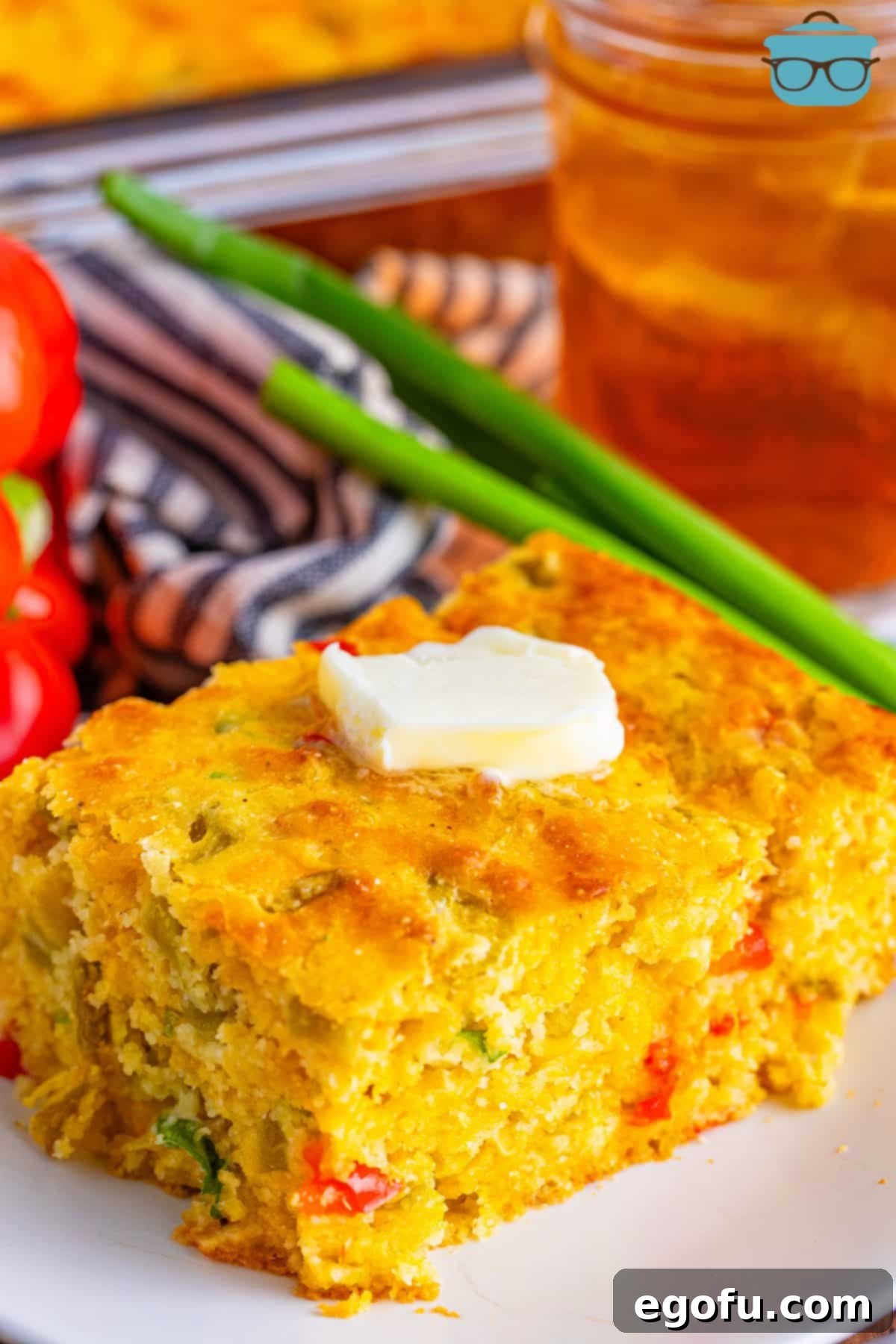A small plate with a large piece of Mexican Cornbread.