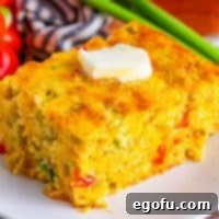 Close up looking at a slice of Mexican Cornbread with a pad of melting butter on top.