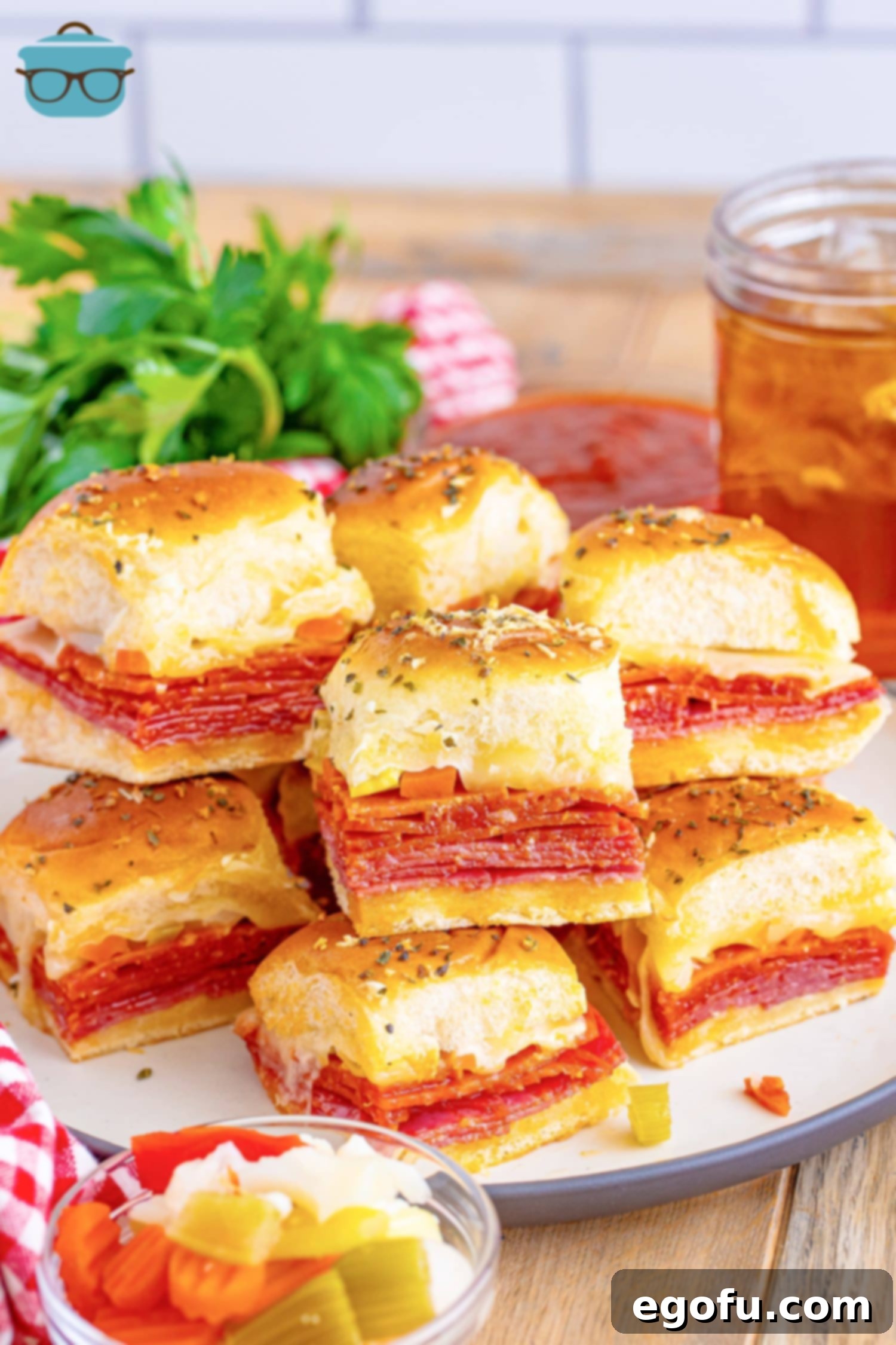 A plate of Italian Sliders stacked high, ready to be enjoyed.