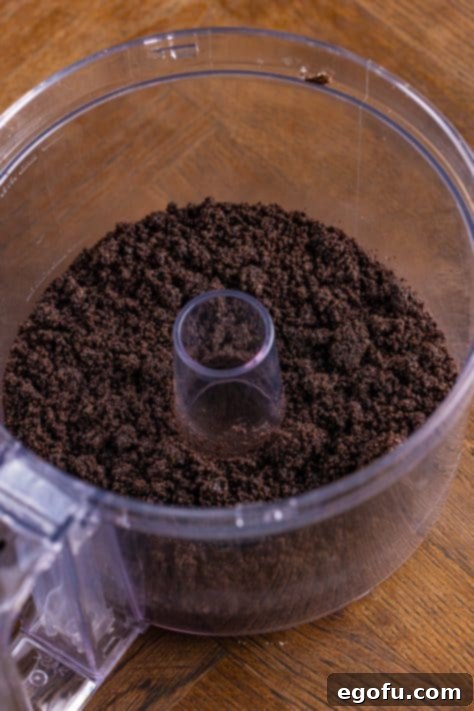 Oreo cookie crumb mixture in a pie pan.