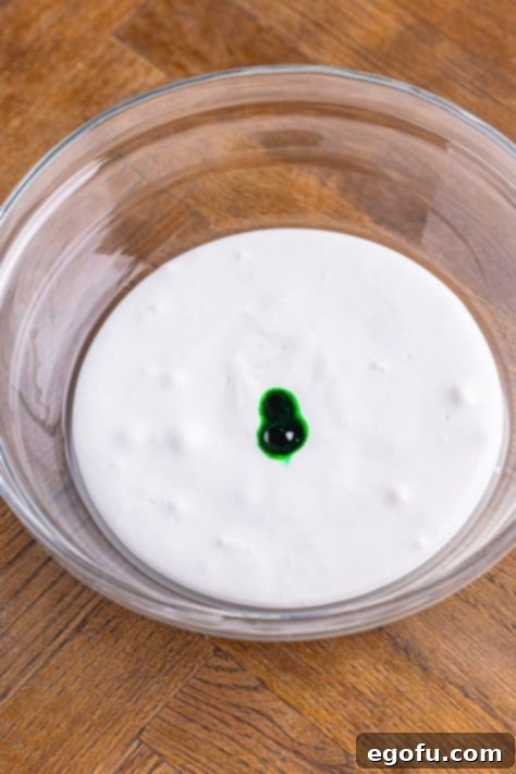 Cream cheese beaten with an electric mixer until smooth in a bowl.