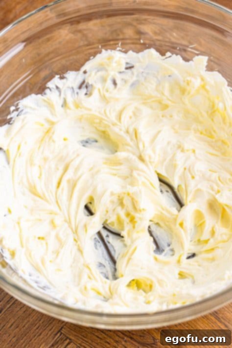 Marshmallow fluff mixture added to cream cheese.