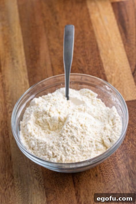 Sweet Blueberry Streusel Cake 12 Flour, baking powder, and salt are whisked together in a bowl with a fork.