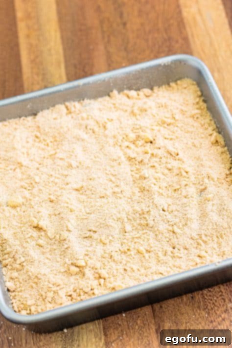 Sweet Blueberry Streusel Cake 19 The delicious crumble topping is generously spread over the blueberry buckle cake batter.