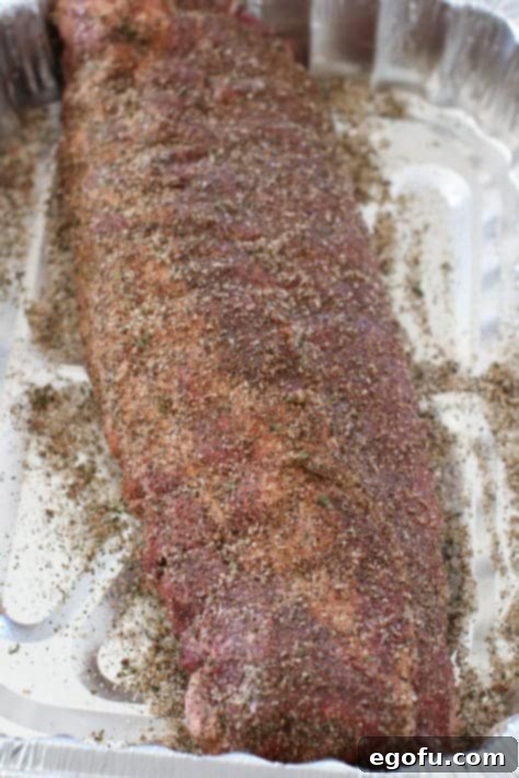 homemade pork bbq rub seasoning on rack of ribs.