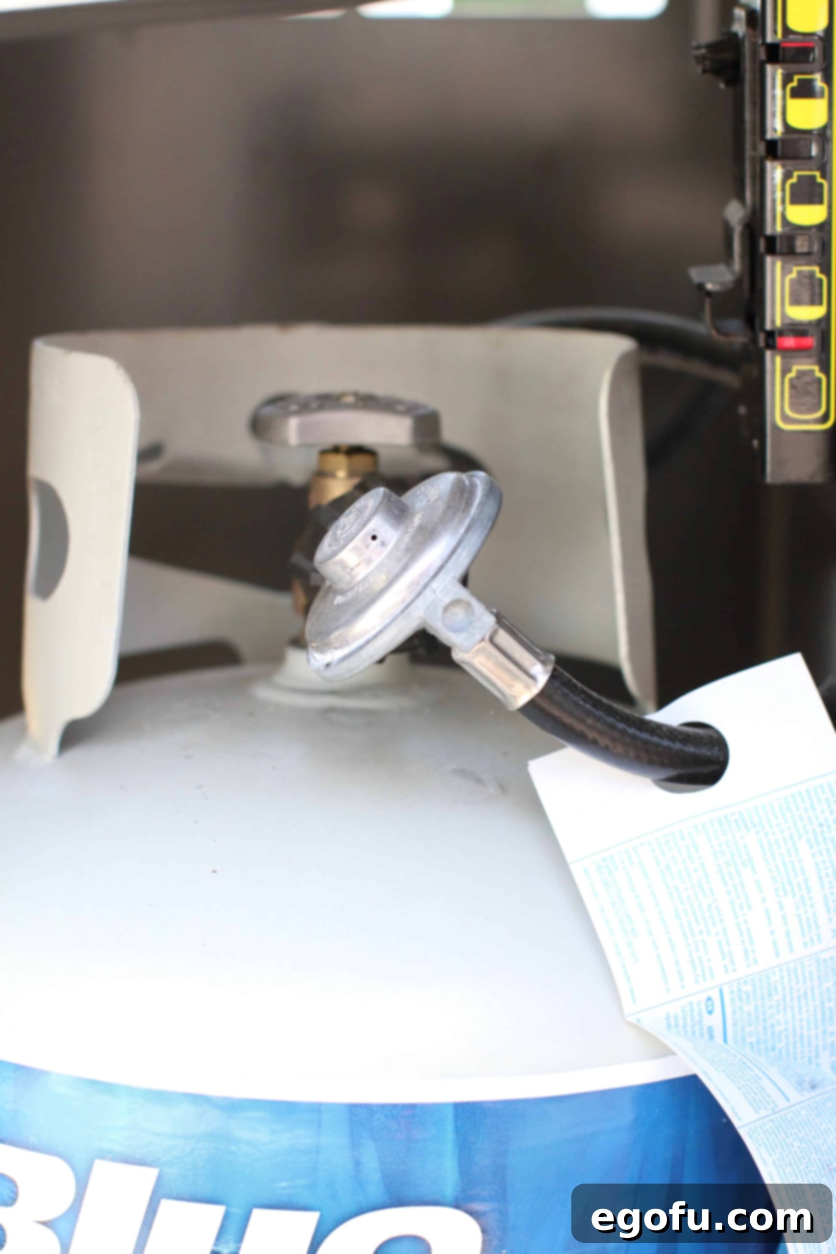 A close-up of a propane gas tank gauge, indicating a full tank, essential for long grilling sessions.