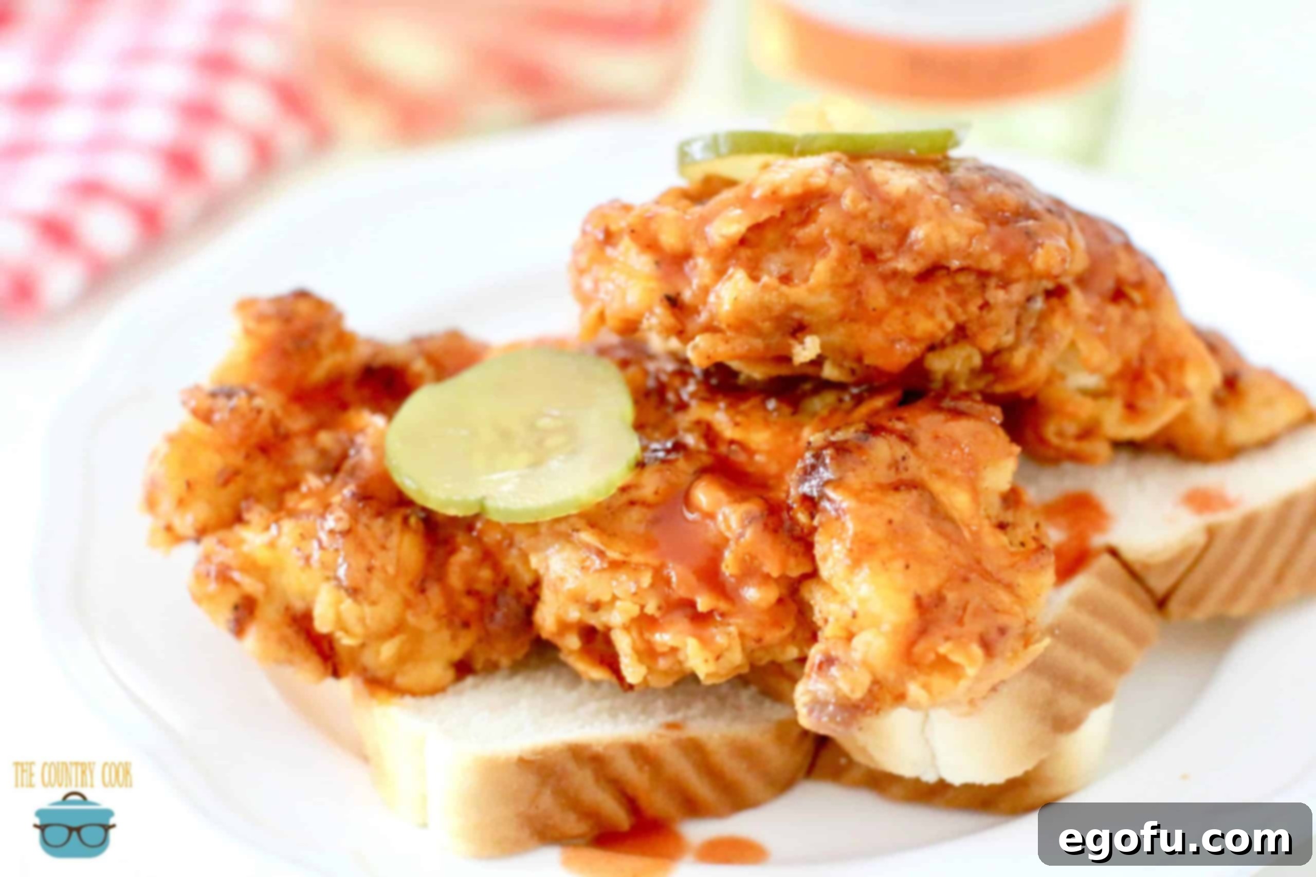 mild version of Nashville Hot Chicken with sliced pickles and sliced white bread, showcasing golden-brown crispy chicken.