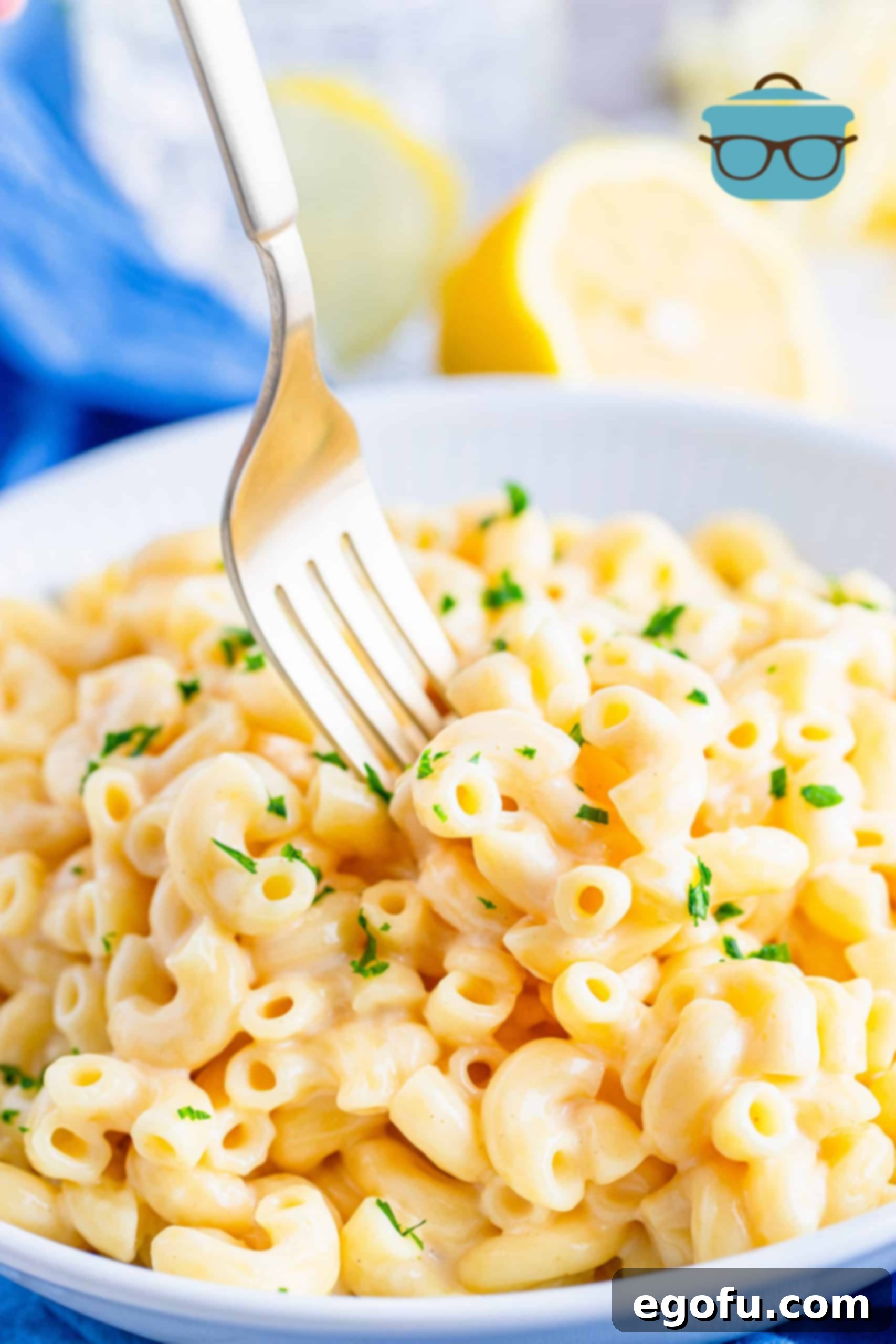 Instant Pot Macaroni and Cheese shown on a white plate with a fork, emphasizing its creamy texture.