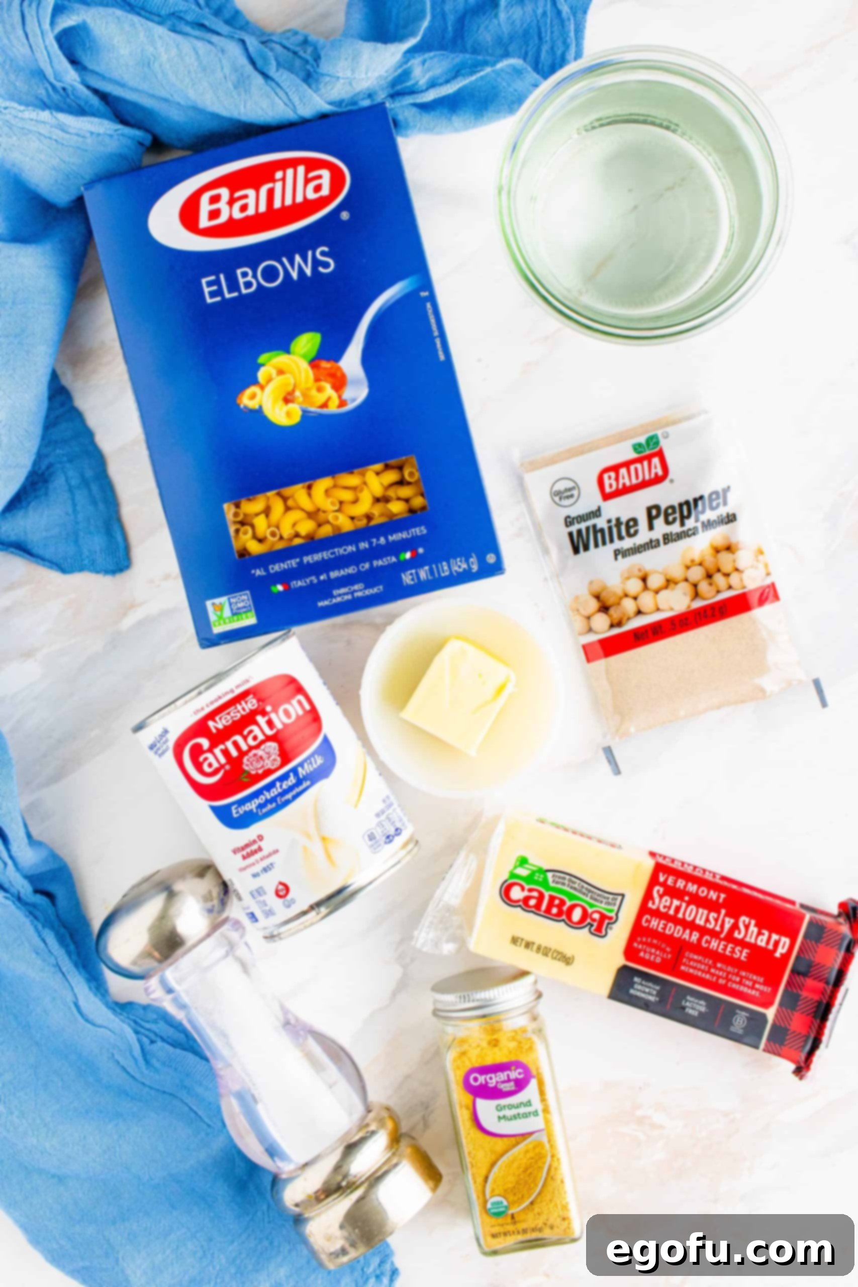 Instant Pot Macaroni and Cheese ingredients: elbow macaroni noodles, water, salted butter, evaporated milk, freshly shredded cheddar cheese, salt, white pepper.