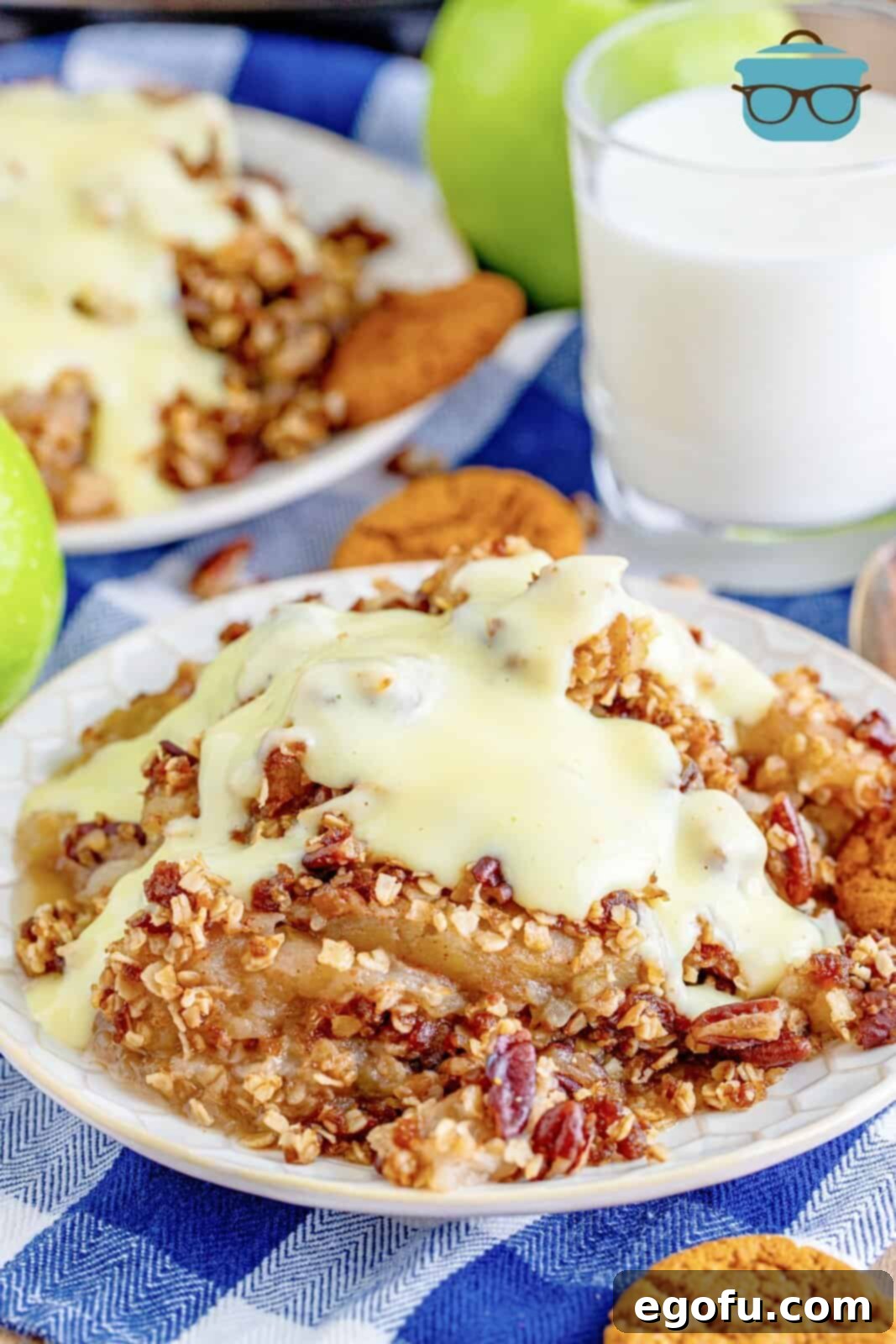 Warm Slow Cooker Apple Crumble 8 A perfectly plated serving of Crock Pot Apple Crisp with warm vanilla sauce generously poured over it, ready to be enjoyed.