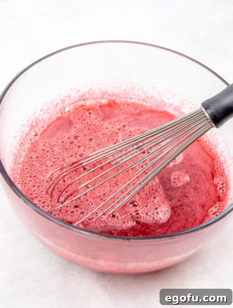cherry Jell-O whisked together with boiling water in a bowl