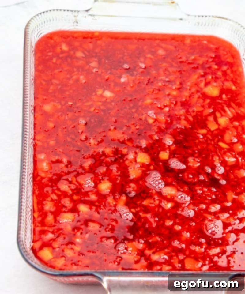 cherry gelatin, cherry pie filling and crushed pineapple in a 9x13 clear baking dish