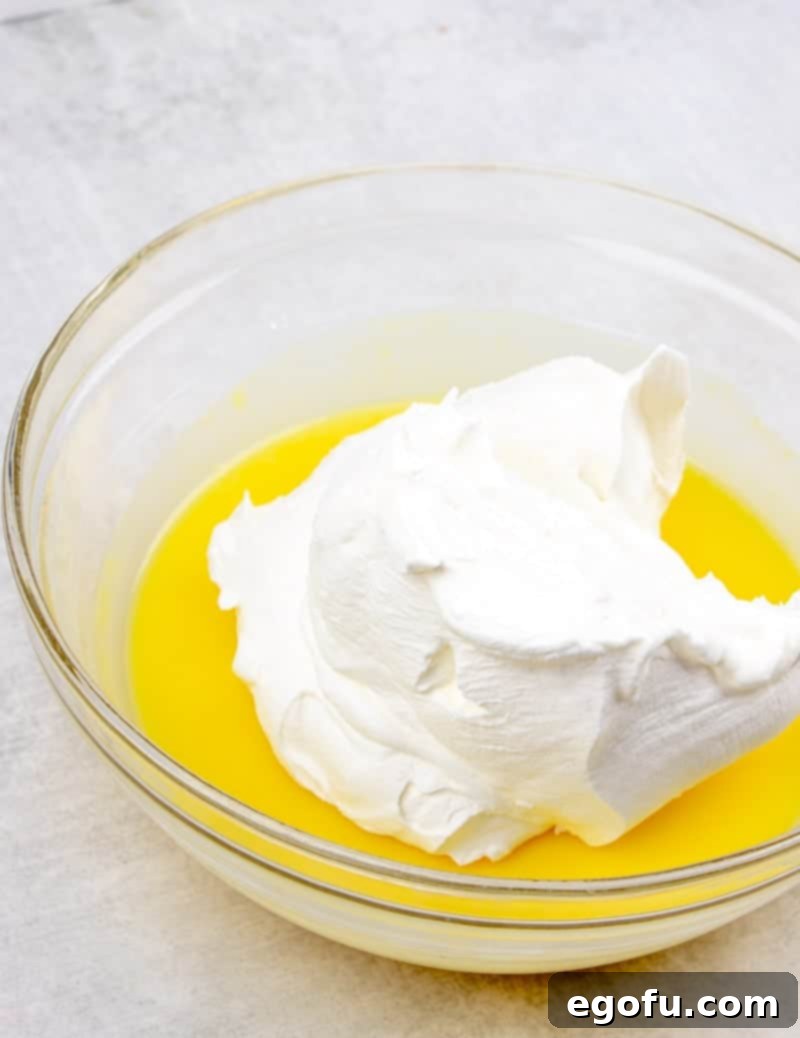 Cool Whip mixed together with instant vanilla pudding and milk in a bowl