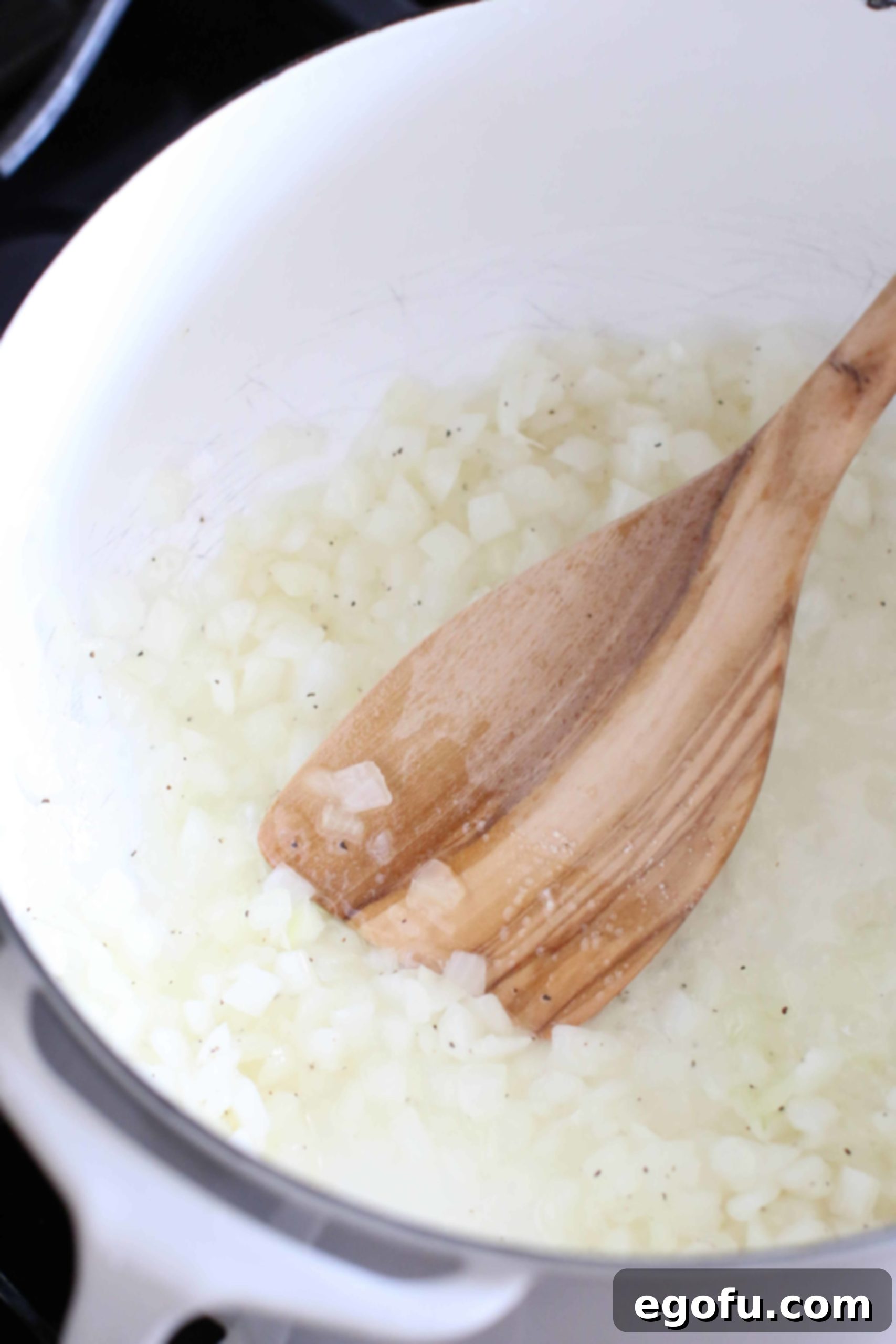 cooking onions in a pot.