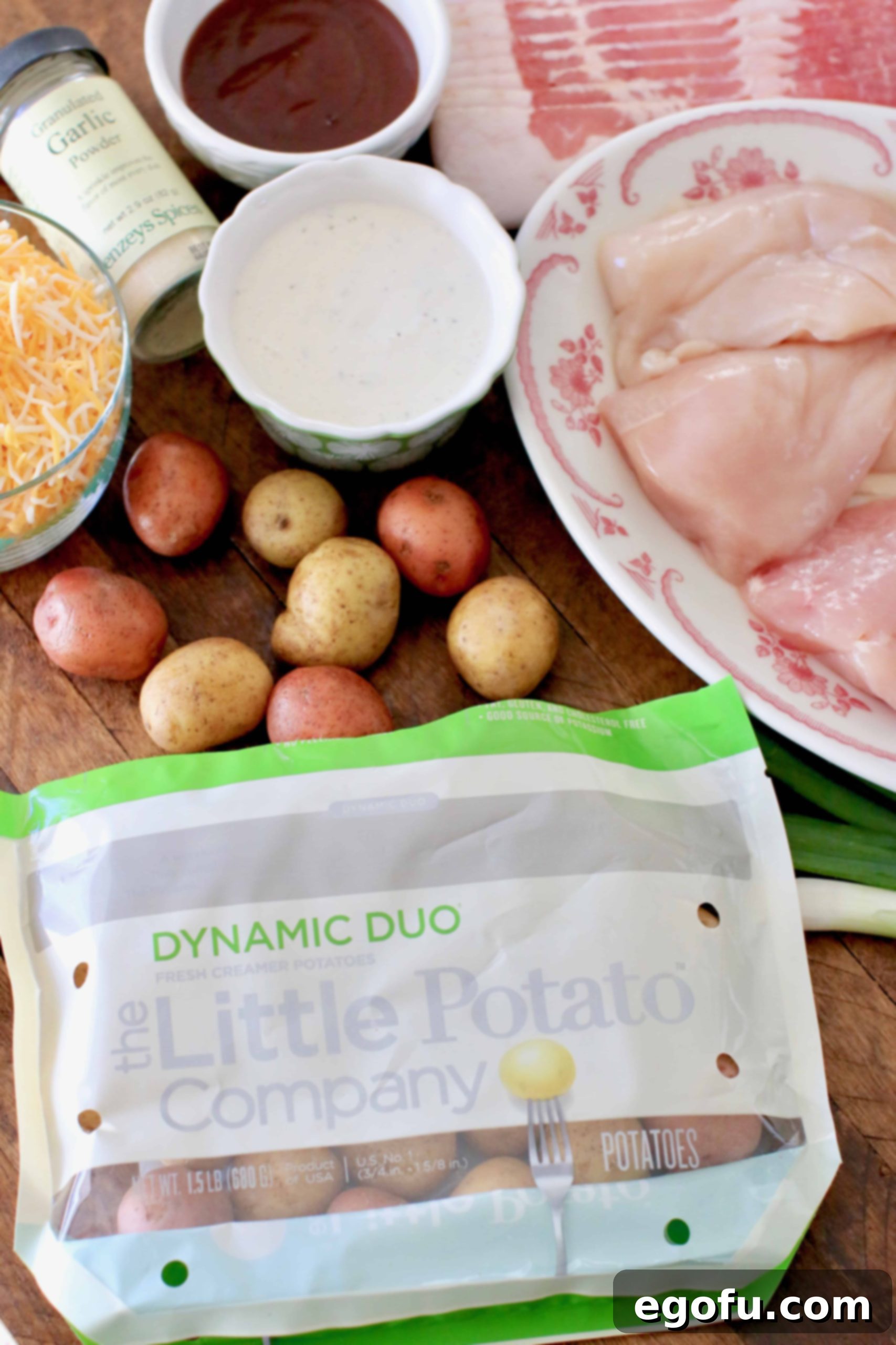 Loaded Cheesy Bacon Chicken and Roasted Potatoes 4 Little Potatoes, shredded cheddar cheese, bacon, chicken, ranch dressing, bbq sauce, green onion.