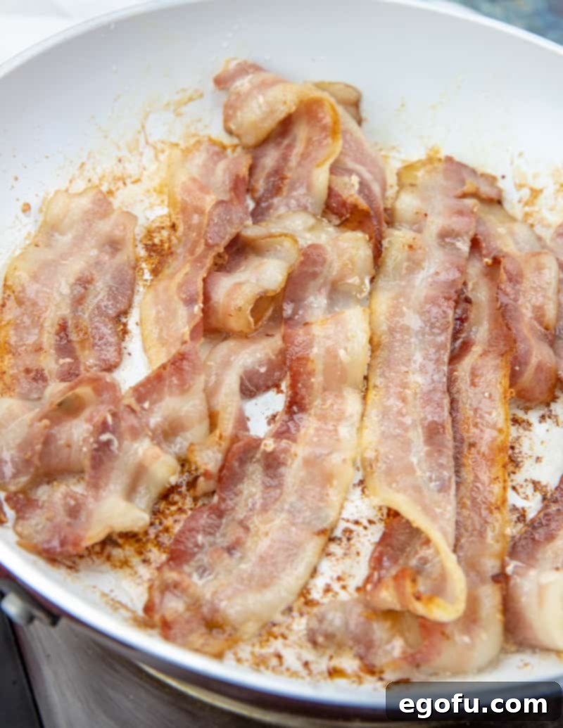 Loaded Cheesy Bacon Chicken and Roasted Potatoes 7 cooked bacon in skillet.