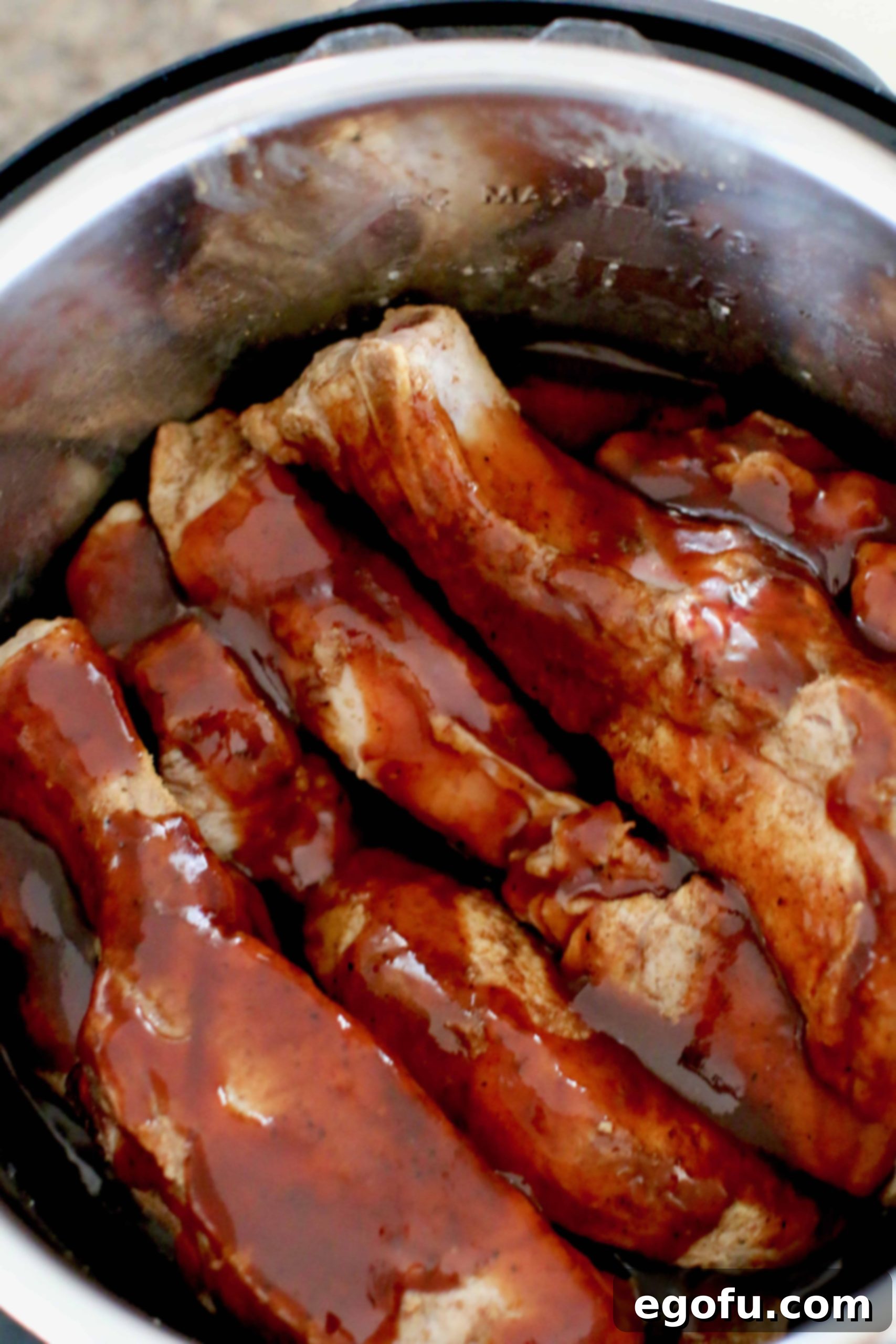 Instant Pot Tender Korean BBQ Country Ribs 8 bbq sauce covered ribs in an instant pot.