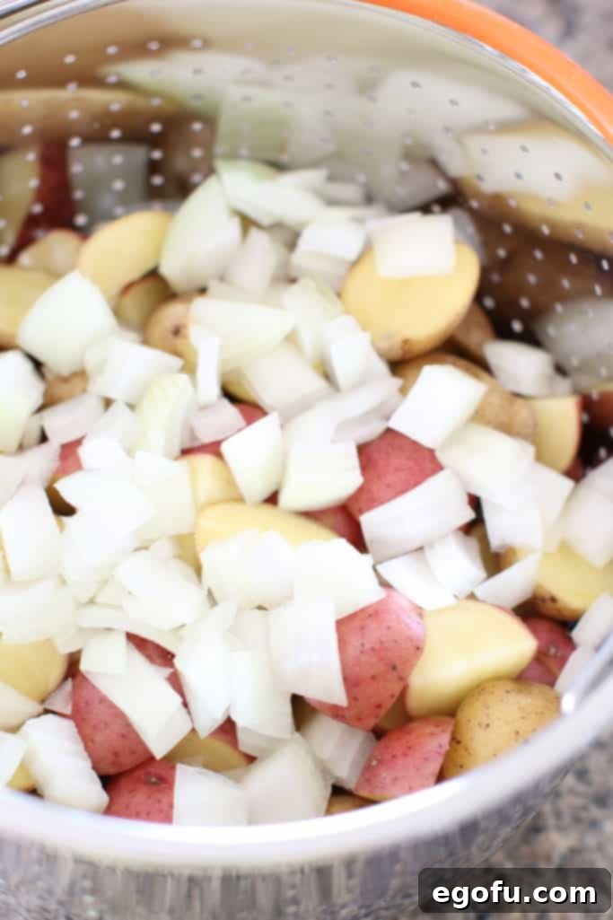 Diced little potatoes and diced onion in an Instant Pot steamer basket
