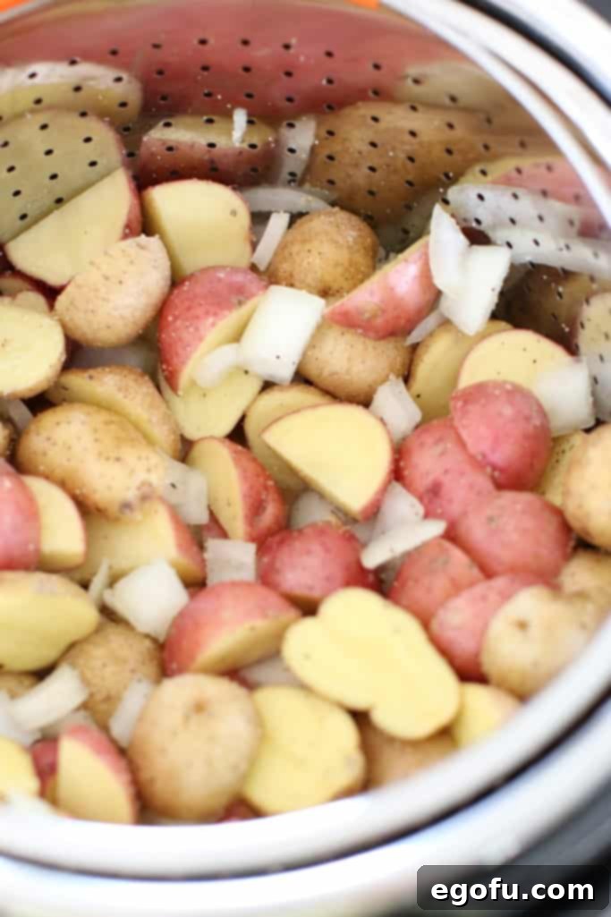 potatoes and onions in steamer basket in Instant Pot.