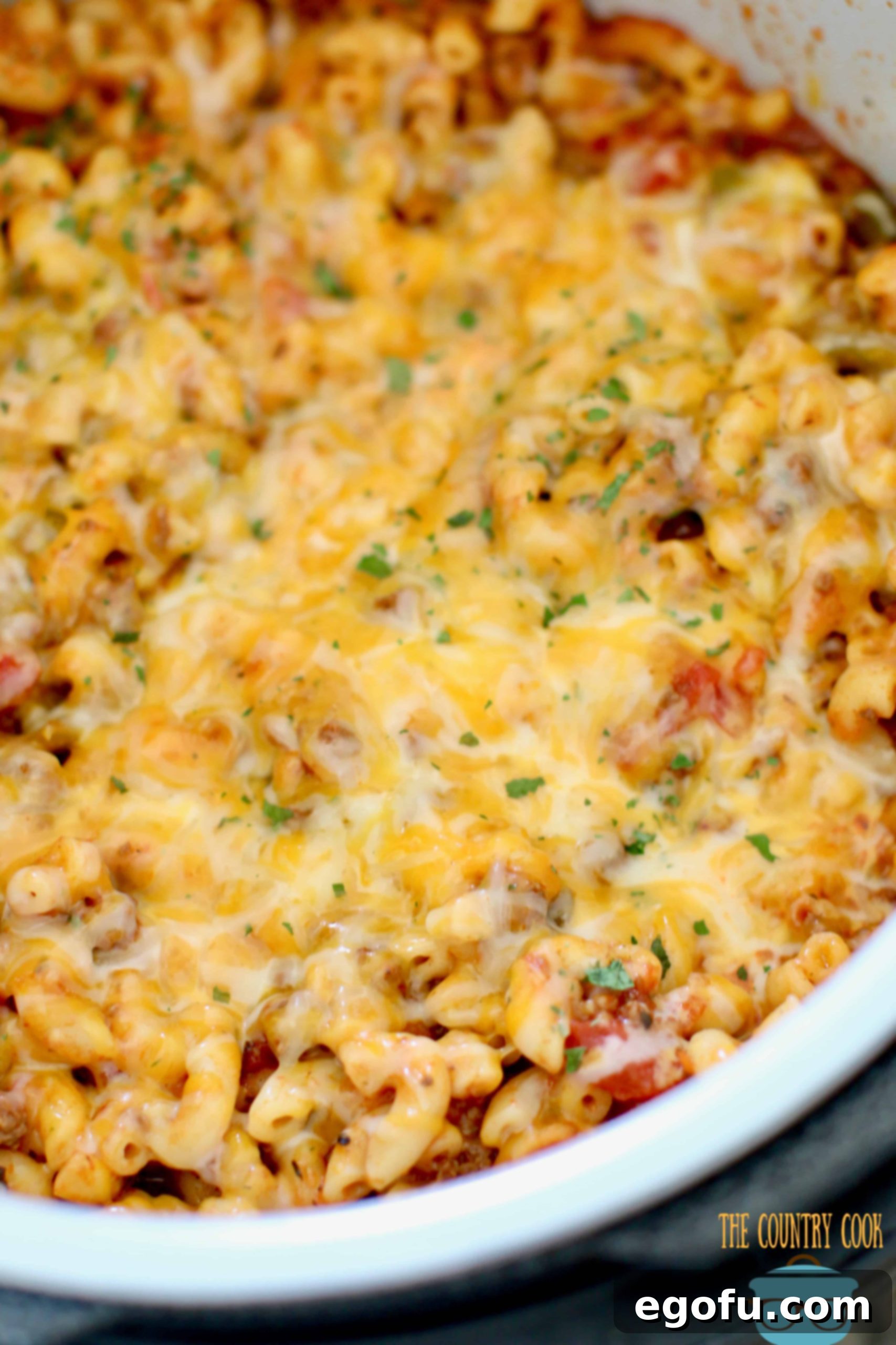 Hearty Instant Pot American Goulash 11 Melted Colby Jack cheese richly covering the surface of finished Instant Pot American Goulash inside the pressure cooker, creating a savory, gooey topping.