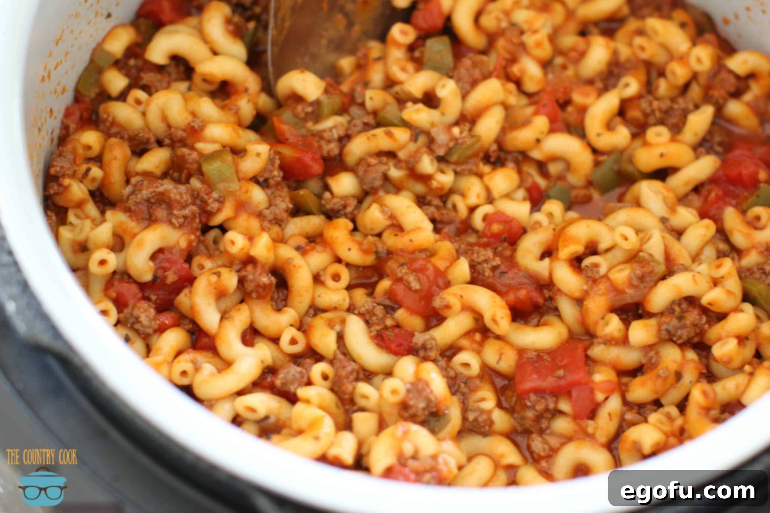 Hearty Instant Pot American Goulash 3 Fully cooked Instant Pot American Goulash in an electric pressure cooker, ready to be served. The rich red sauce and macaroni noodles are clearly visible, with steam gently rising.