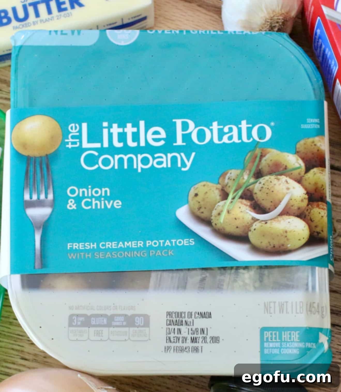 Packaging for Onion and Chive Little Potatoes, highlighting their oven and grill readiness.
