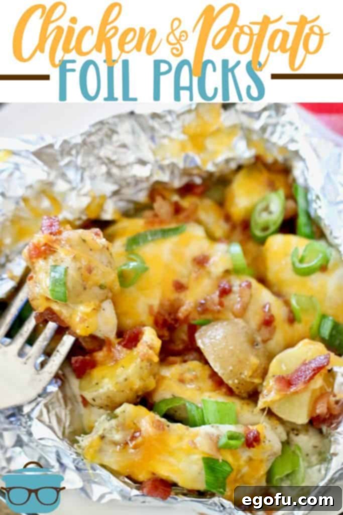 An opened chicken and potato foil pack, with a fork lifting a cheese-covered potato, showcasing the deliciousness of the recipe.