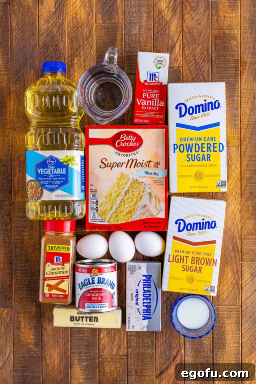 Cinnamon Swirl Poke Cake 4 A vibrant collage of key ingredients: vanilla cake mix, cream cheese, butter, sweetened condensed milk, brown sugar, and cinnamon, neatly arranged to inspire baking.