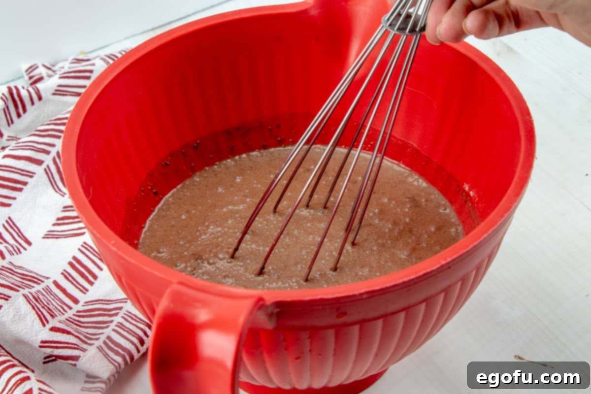 instant chocolate pudding whisked together in a red bowl.