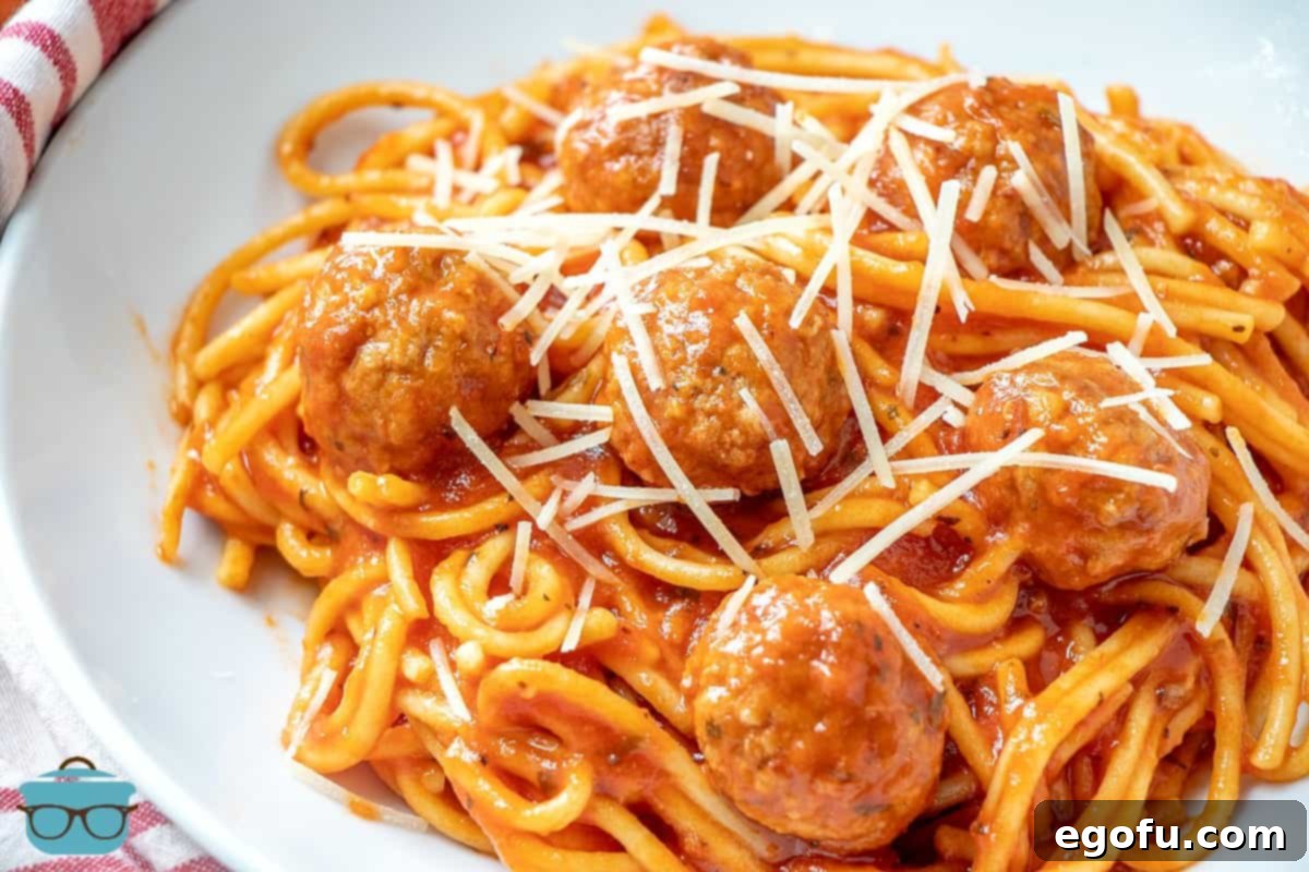 One-Pot Wonder: Instant Pot Spaghetti & Meatballs 2 Instant Pot Spaghetti on a plate topped with shredded Parmesan Cheese.