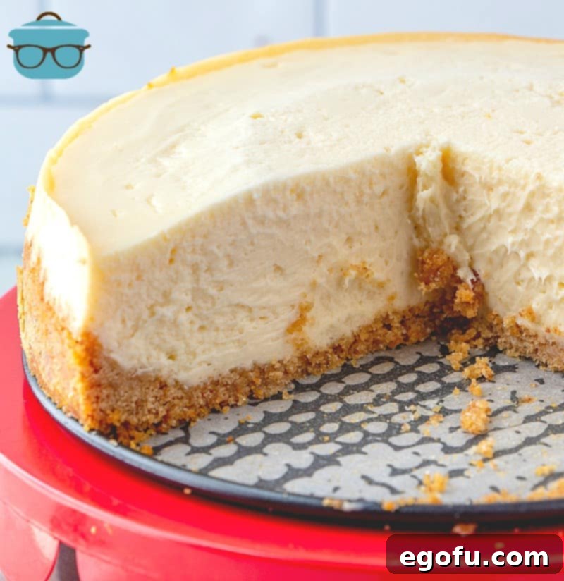 The Ultimate Instant Pot Cheesecake 13 sliced, Instant Pot Cheesecake on a cake stand.