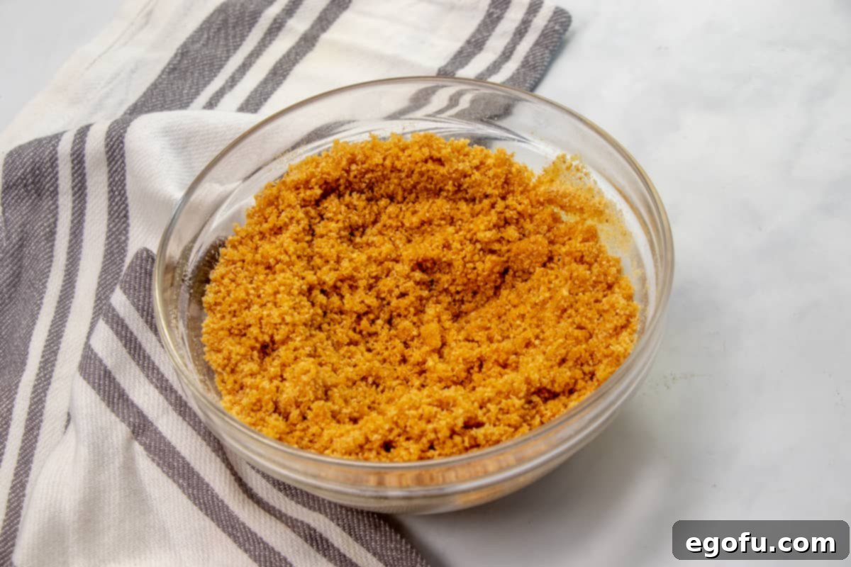 The Ultimate Instant Pot Cheesecake 5 graham crackers, sugar and melted butter mixed together in a bowl.