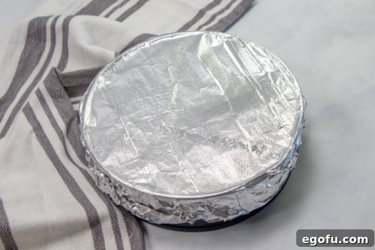 The Ultimate Instant Pot Cheesecake 10 aluminum foil covered springform pan.