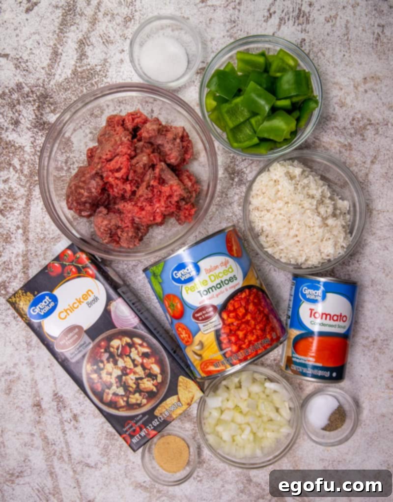 Deconstructed Stuffed Pepper Soup 4 A visual display of all the fresh and canned ingredients needed to make Instant Pot Stuffed Pepper Soup: lean ground beef, a small yellow onion, two green bell peppers, a bowl of uncooked long-grain rice, sugar, garlic powder, salt and pepper, a can of diced tomatoes with basil, garlic and oregano, a can of tomato soup, chicken broth, and a pile of shredded cheddar cheese.