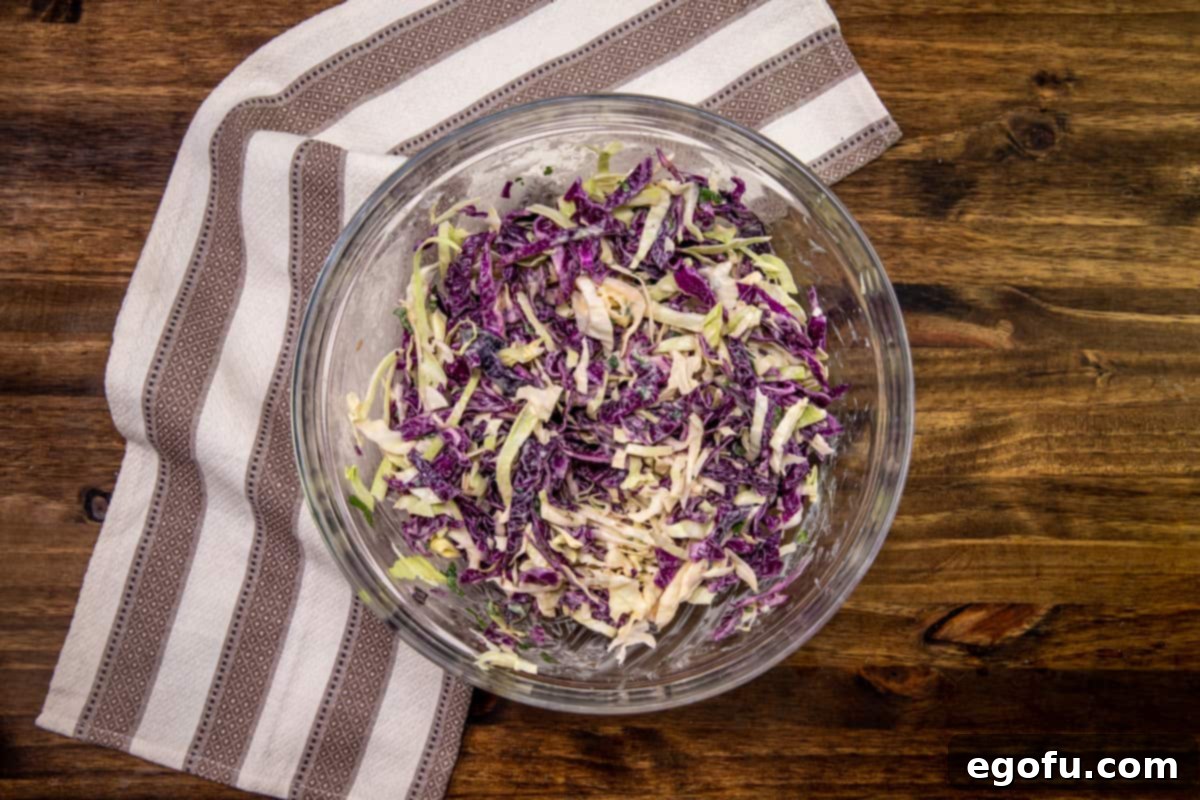 Irish coleslaw, stirred together in a clear bowl.