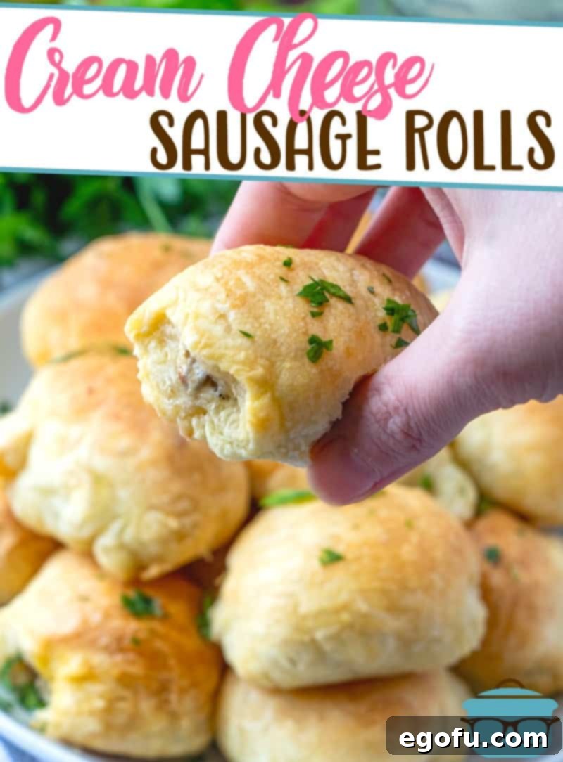 Sausage Rolls with Flaky Pastry 3 A hand holding up one of the golden brown, flaky 3-Ingredient Puff Pastry Cream Cheese Sausage Rolls.