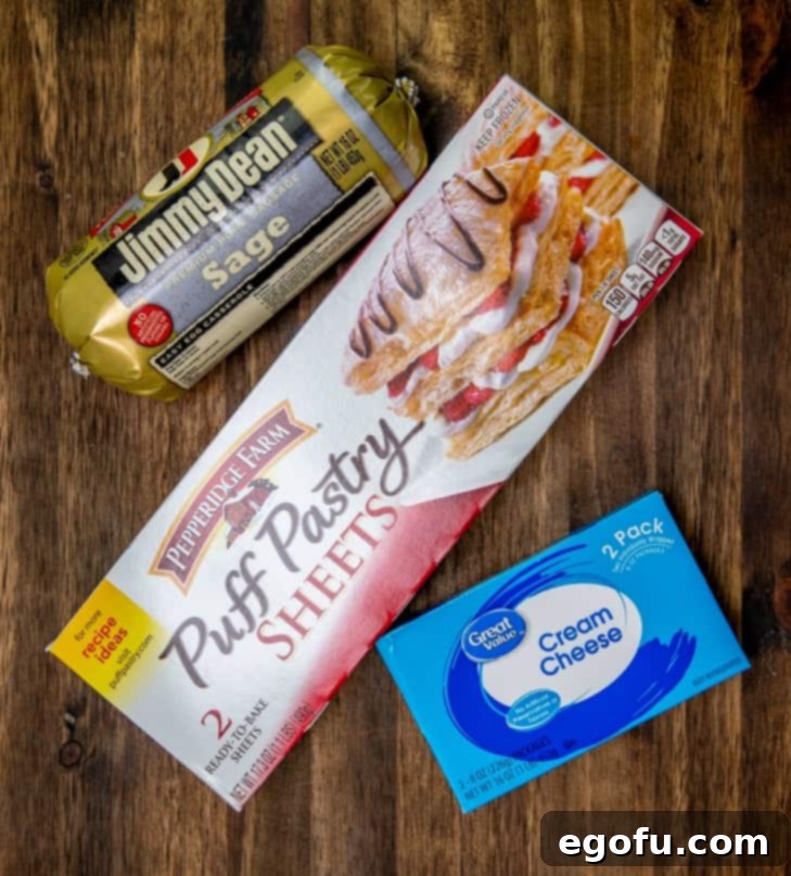 Sausage Rolls with Flaky Pastry 4 Close-up of the three core ingredients: thawed puff pastry, a block of cream cheese, and a package of sage pork sausage.