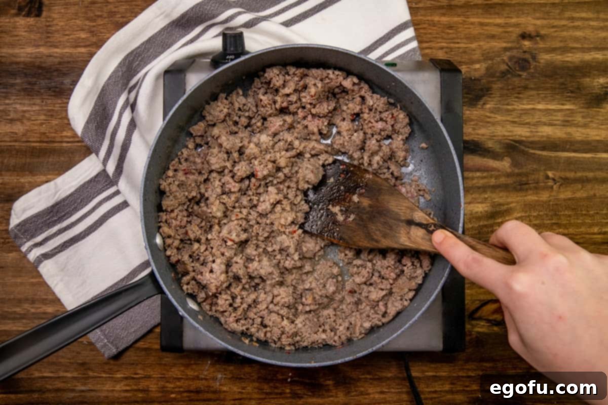 Sausage Rolls with Flaky Pastry 5 Close-up of ground pork sausage cooked and crumbled in a skillet.